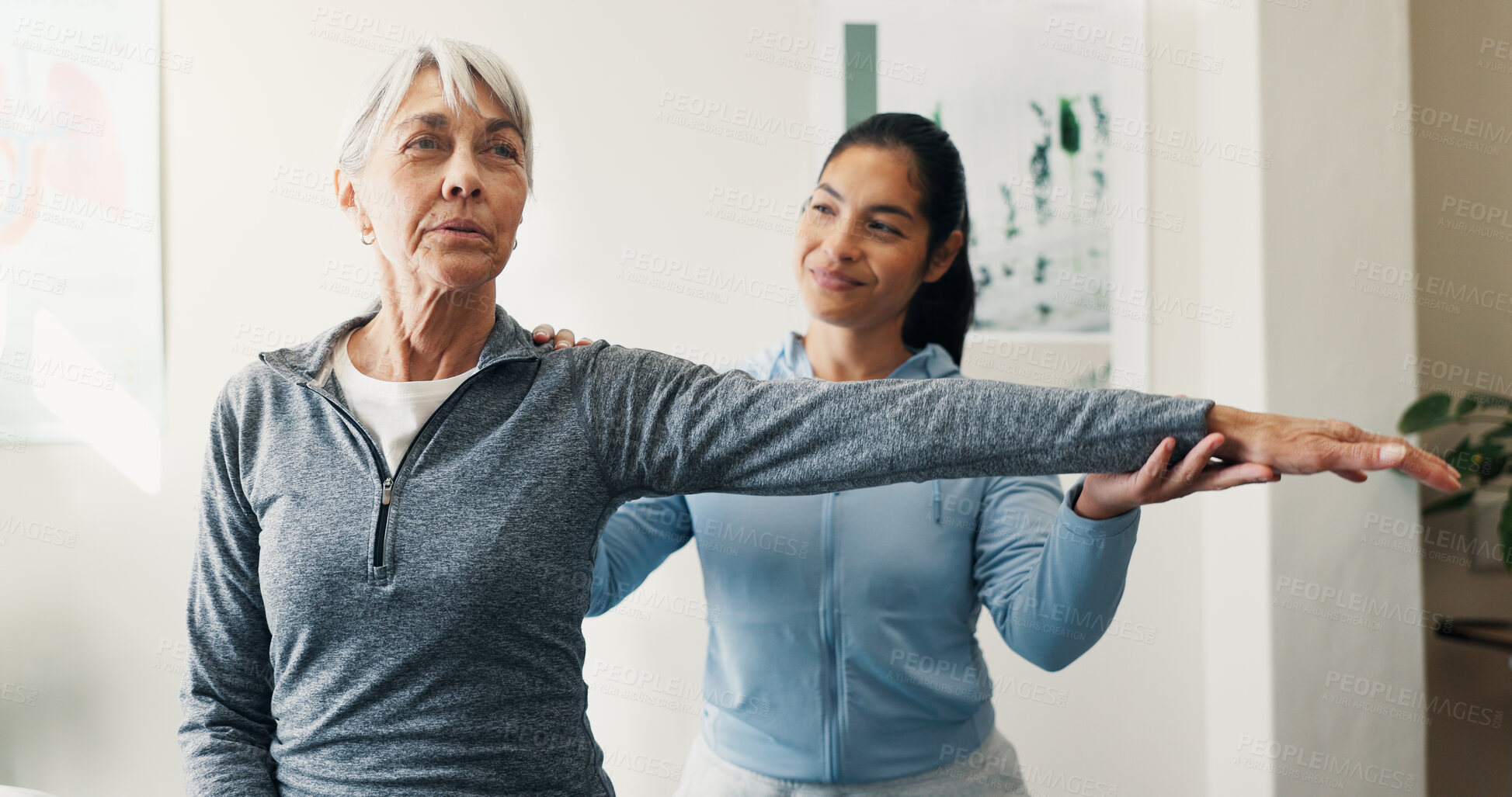 Buy stock photo Smile, old woman and stretching in office for physio, assessment and recovery from injury. Physiotherapist, help and senior person at clinic for physical therapy, evaluation and muscle rehabilitation