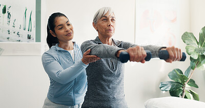 Buy stock photo Smile, old woman and stretching with dumbbells for physio, assessment and mobility recovery. Physiotherapist, help and senior person in office for physical therapy, fitness and muscle rehabilitation