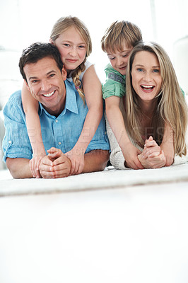 Buy stock photo Floor, space and portrait of children with parents in home for care, love and weekend bonding. Happy, relax and kids with mom and dad on carpet for family connection or safety in living room.