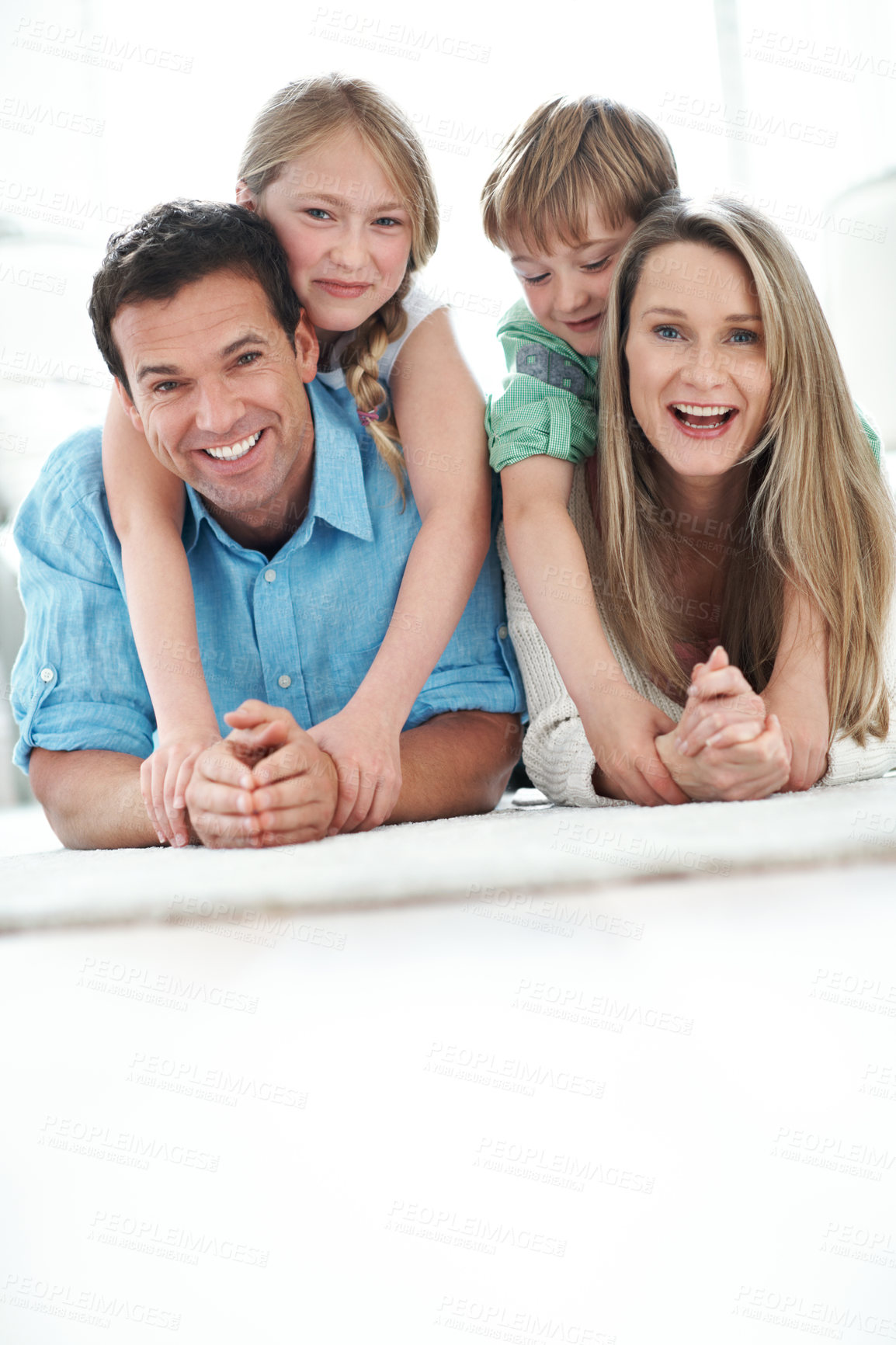 Buy stock photo Floor, space and portrait of children with parents in home for care, love and weekend bonding. Happy, relax and kids with mom and dad on carpet for family connection or safety in living room.