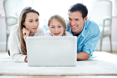 Buy stock photo Parents, online and child with laptop in lounge, smile and watching film with subscription in house. Streaming, movie and happy people with kid, family and relax with tech for entertainment in home