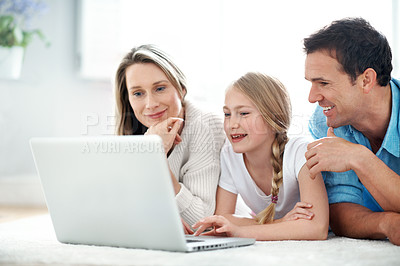 Buy stock photo Parents, laughing and child with laptop in lounge, smile and watching film with subscription in home. Streaming, comedy and happy people with kid, family or relax with tech for entertainment in house