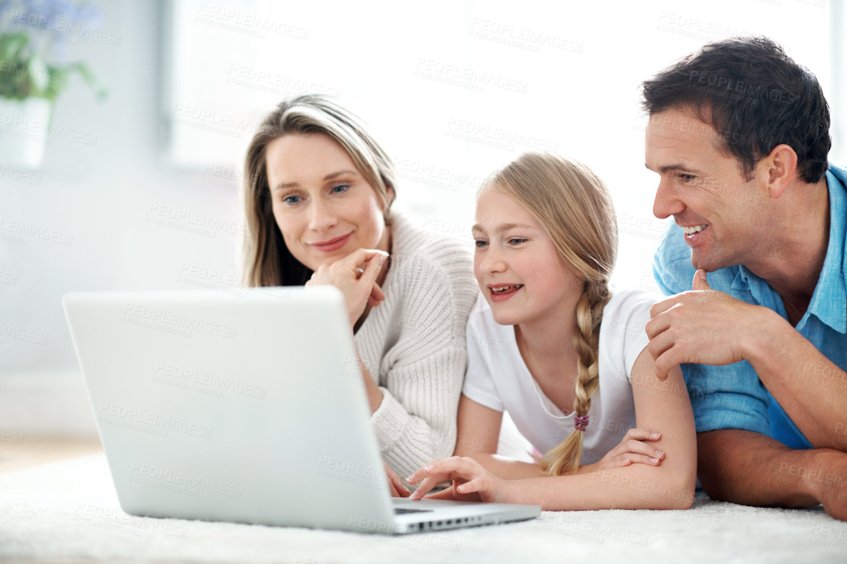 Buy stock photo Parents, laughing and child with laptop in lounge, smile and watching film with subscription in home. Streaming, comedy and happy people with kid, family or relax with tech for entertainment in house