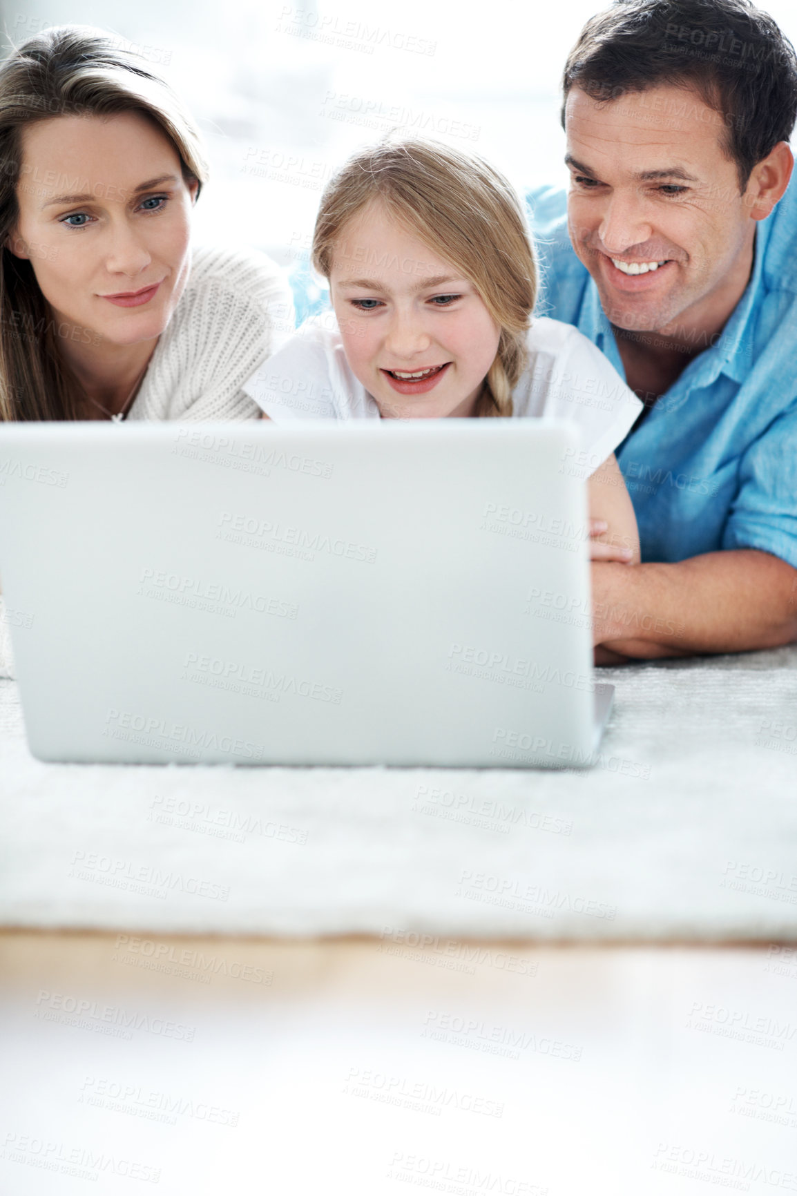 Buy stock photo Parents, bonding and child with laptop in lounge, smile and watching film with subscription in house. Streaming, movie and happy people with kid, family and relax with tech for entertainment in home