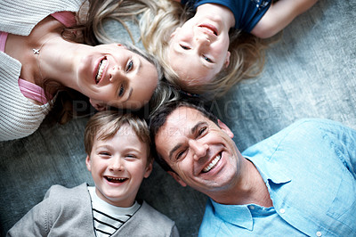 Buy stock photo Portrait, parents and relax on floor with children, love and parental support for bonding together. Above, people and happiness at house with kids, comfortable and family connection for weekend break