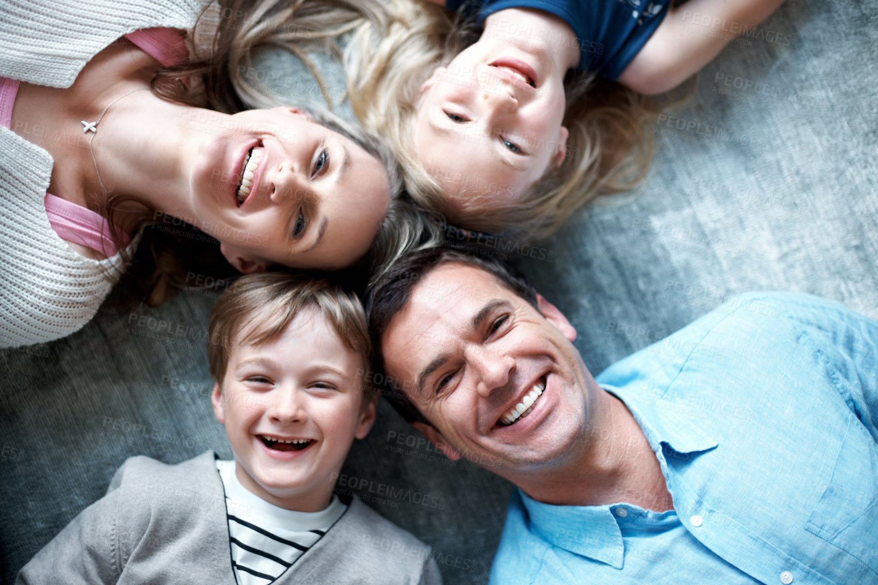 Buy stock photo Portrait, parents and relax on floor with children, love and parental support for bonding together. Above, people and happiness at house with kids, comfortable and family connection for weekend break