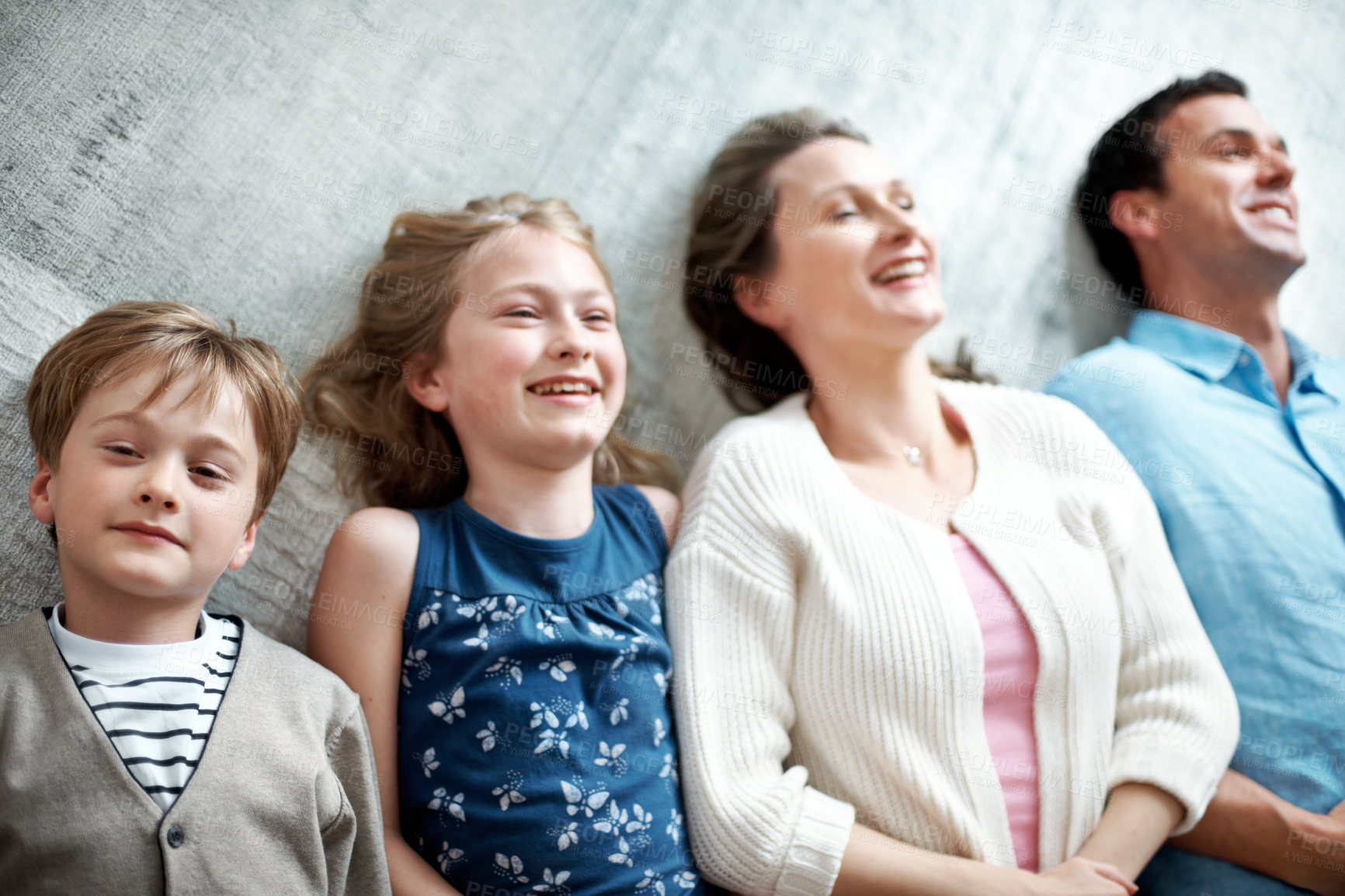 Buy stock photo Smile, parents and relax on floor with children, love and parental support for bonding together. Above, people and portrait at house with kids, comfortable and family connection for weekend break