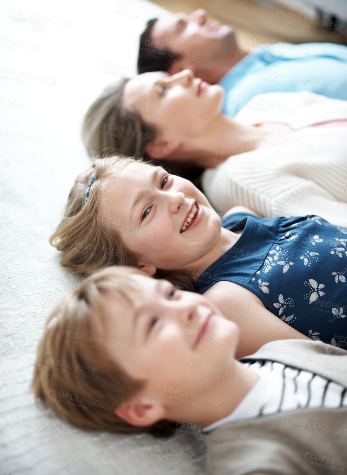 Buy stock photo Children, smile and bonding with parents on floor, resting and comfortable on weekend in living room. Family, home and connection with kids on break, portrait and happy people on peaceful holiday
