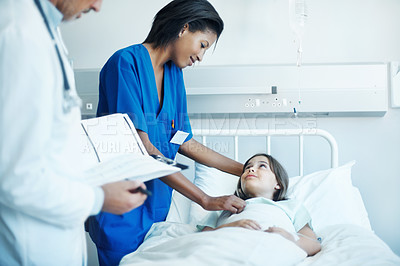 Buy stock photo Doctor, nurse and sick child in hospital with clipboard, wellness survey or medical support for healing. Girl, healthcare team and consultation in clinic with checklist, evaluation and assurance.