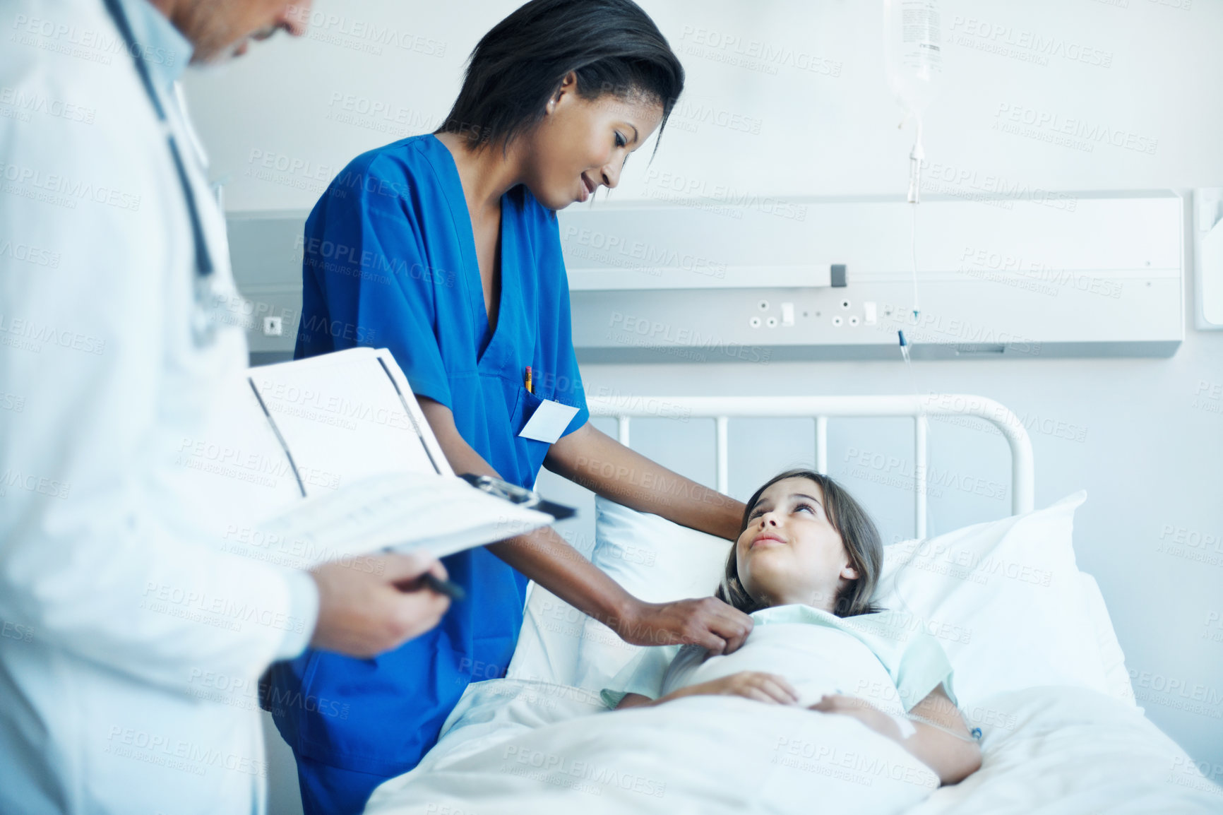 Buy stock photo Doctor, nurse and sick child in hospital with clipboard, wellness survey or medical support for healing. Girl, healthcare team and consultation in clinic with checklist, evaluation and assurance.
