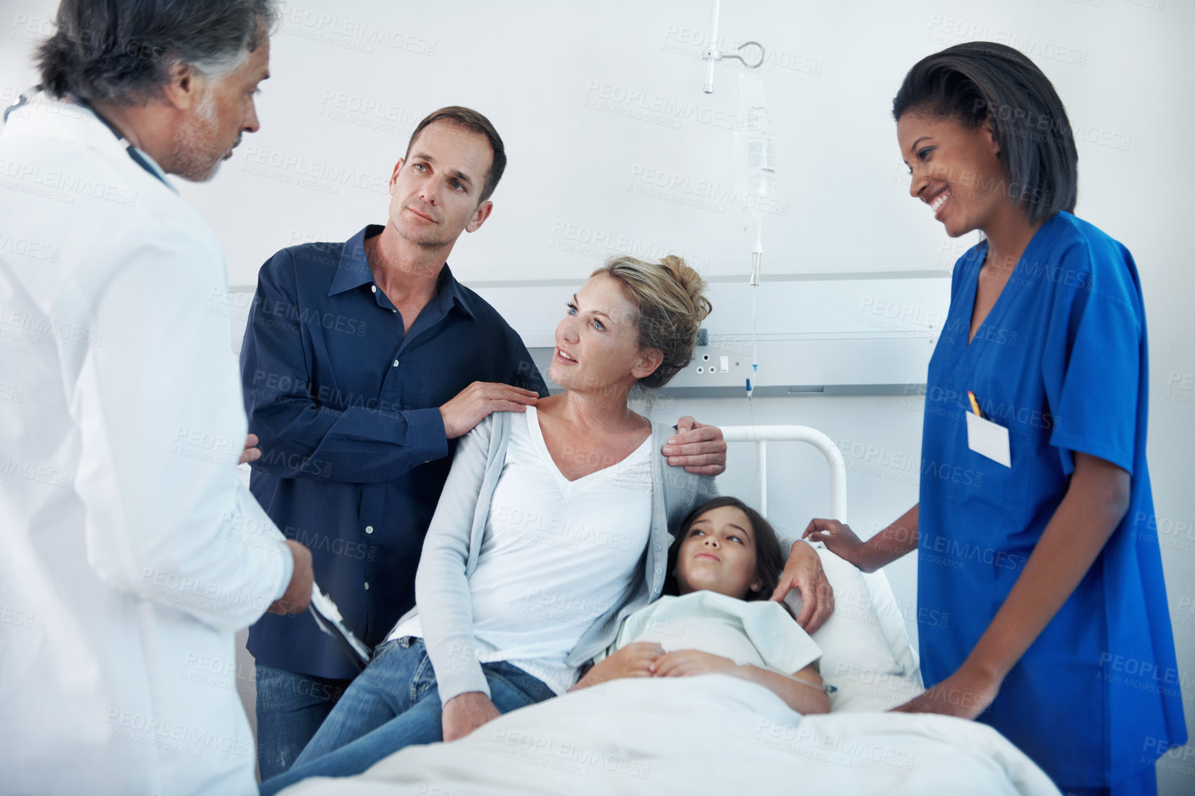 Buy stock photo Parents, consultation and child in hospital bed with medical team, specialist and treatment discussion. Mother, father and checkup in clinic with daughter, healthcare people and advice for recovery.