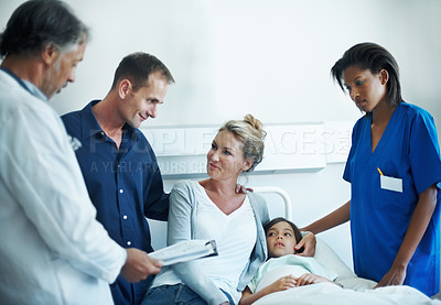Buy stock photo Parents, kid and medical team in hospital with clipboard, health insurance and treatment discussion. Mother, happy father and consultation in clinic with girl child, healthcare people and checklist