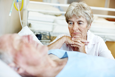 Buy stock photo Sad, sick and senior couple in hospital for recovery with empathy, love and commitment. Retirement, sleeping and elderly woman with man for rehabilitation with comfort, care and bonding in clinic.