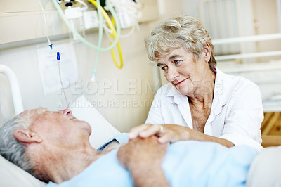 Buy stock photo Hospital bed, visit and senior couple for support, commitment and love for surgery recovery. Happy, healthcare and elderly man and woman with comfort, affection and care for healing and wellness