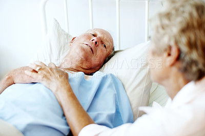Buy stock photo Hospital, old couple and man in bed with support, commitment and love for surgery recovery. Marriage, healthcare and elderly patient and woman with comfort, affection or care for healing and wellness