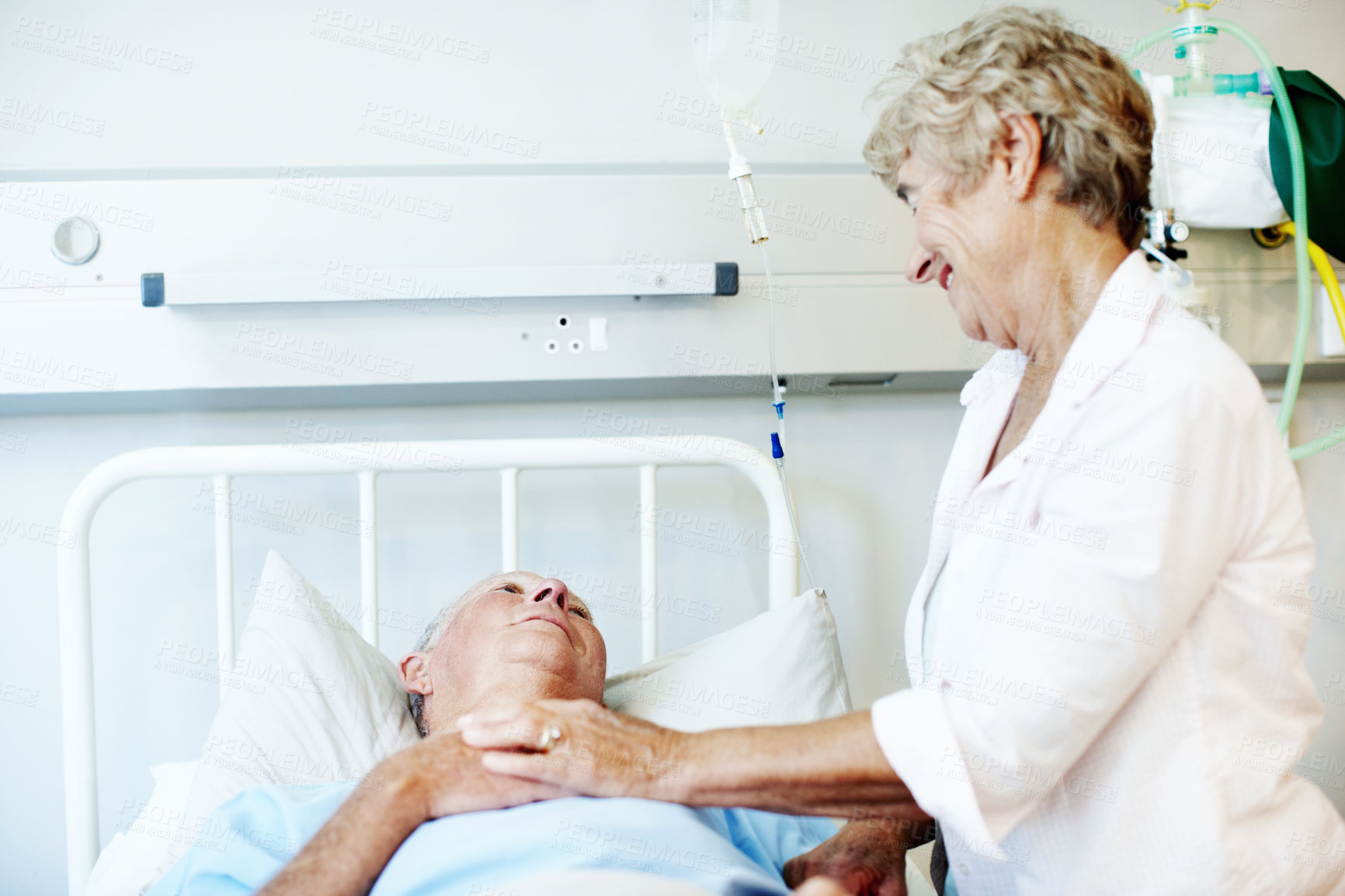 Buy stock photo Hospital bed, comfort and senior couple for support, commitment and love for surgery recovery. Happy, healthcare and elderly man and woman with compassion, affection and care for healing and wellness