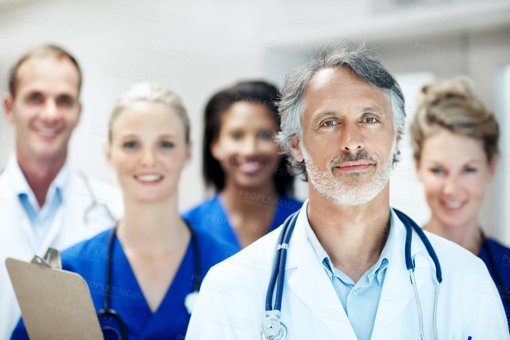 Buy stock photo Team, portrait and man with doctors in hospital for healthcare, solidarity and consulting. Medical, nurses and about us with people in hallway of clinic for support, community and collaboration