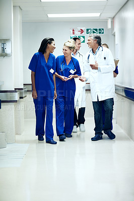 Buy stock photo Team, talking and walk with doctors in hospital for healthcare, solidarity and consulting. Medical, community and discussion with group of people in hallway of clinic for support and collaboration