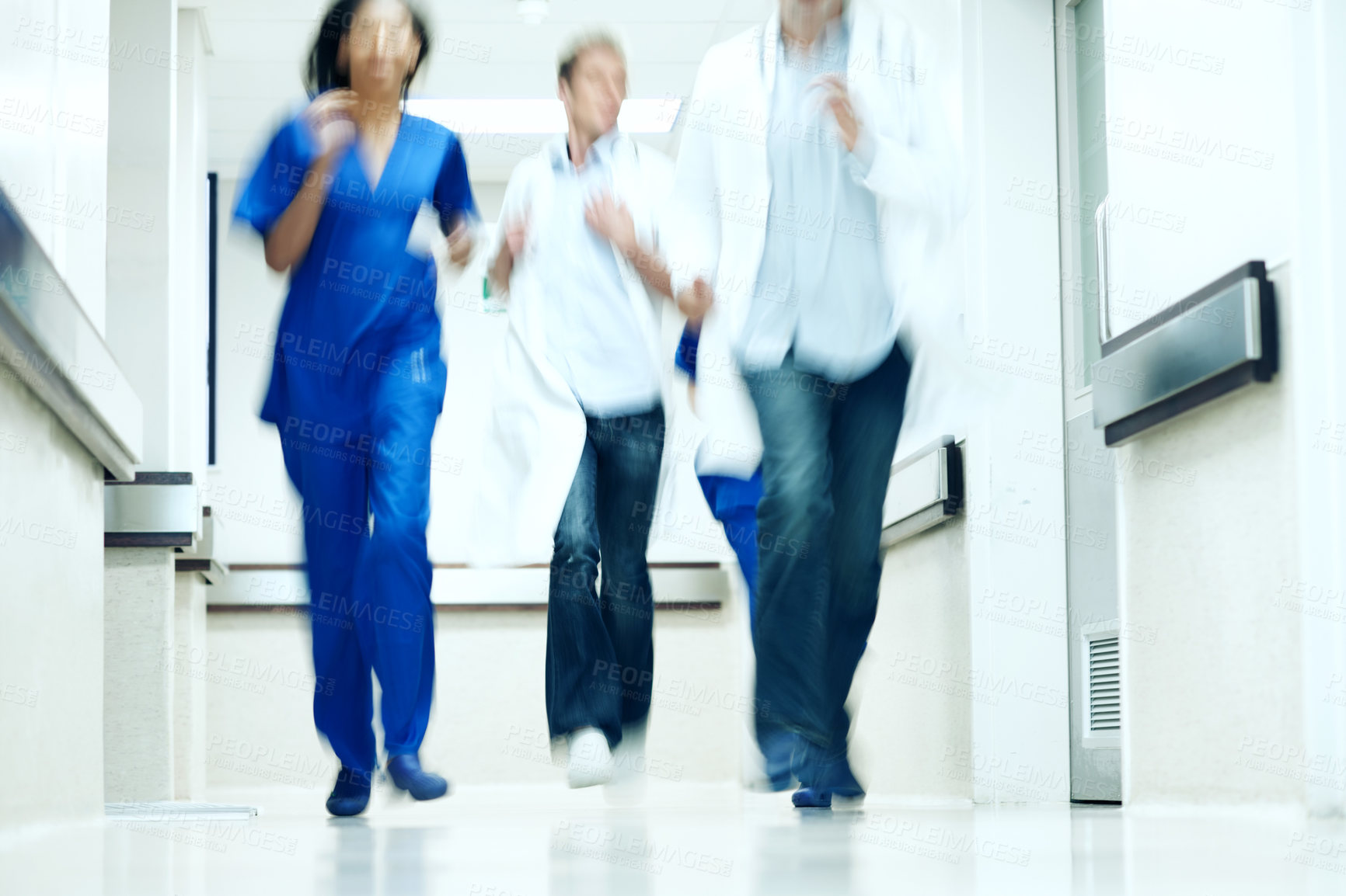 Buy stock photo Running, team and corridor with doctors in hospital for emergency,  motion blur and medical crisis. Accident, healthcare rush and wellness with people for support, urgency and code blue alert