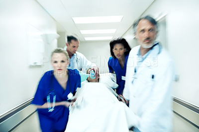 Buy stock photo Surgery, emergency and motion blur with doctors in hospital for running, medical crisis and accident. Healthcare, injury and operation with people and patient in clinic for saving life, help and rush