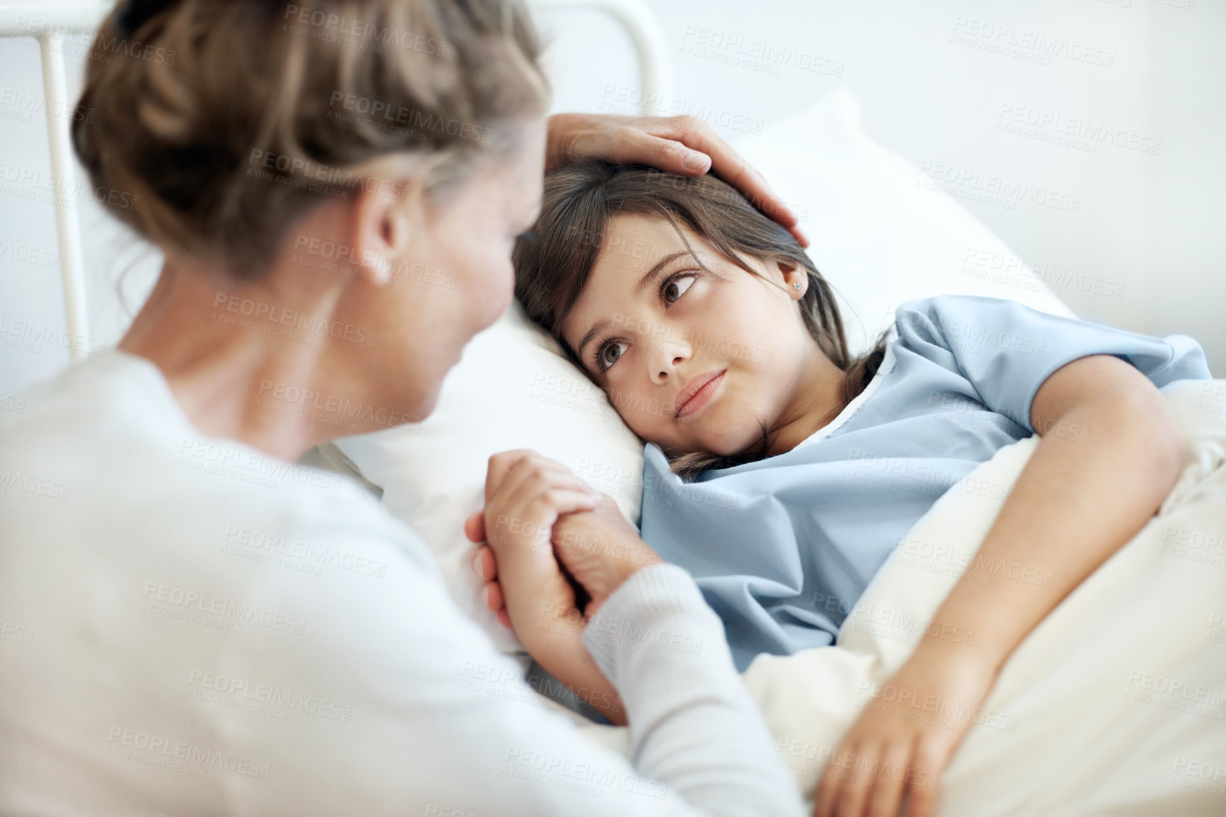 Buy stock photo Mother, child and holding hands in hospital bed with comfort, love and support for virus recovery. Woman, console sick daughter and bonding in medical clinic with care, empathy and rehabilitation.