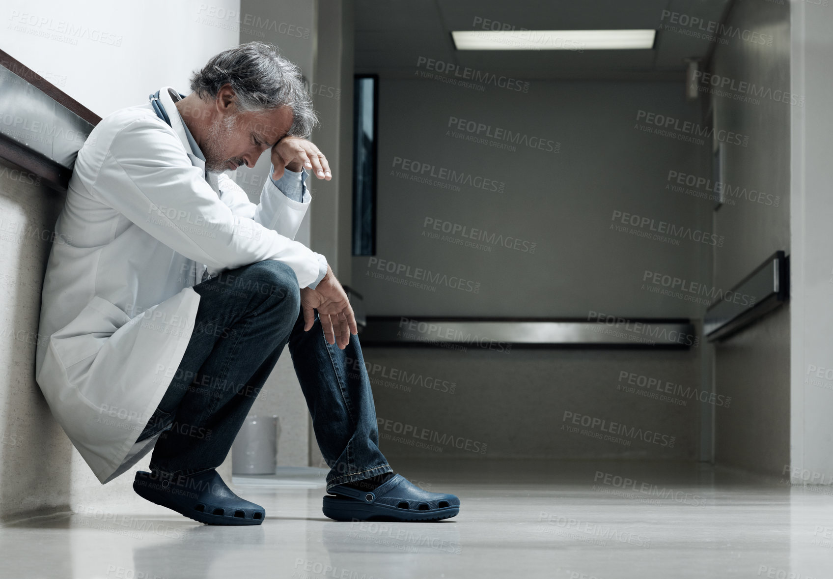 Buy stock photo Doctor, stress and thinking with man in hospital for medical fail, reflection and emergency risk. Healthcare, career burnout and perspective with mature person with depression in clinic for error