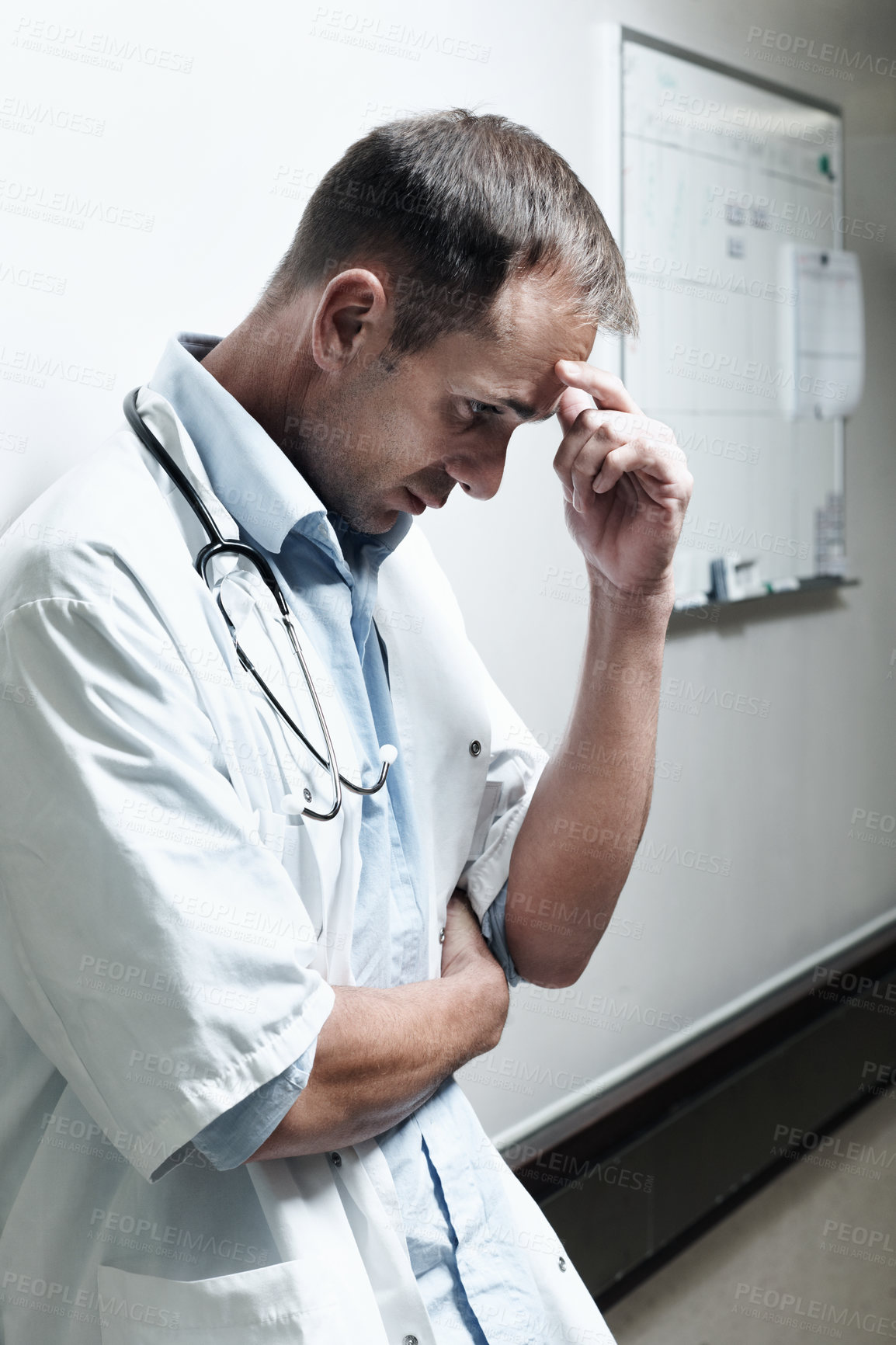 Buy stock photo Doctor, sad and reflection with man in hospital for medical fail, thinking and emergency risk. Healthcare, career burnout and perspective with person with depression in hallway in clinic for error