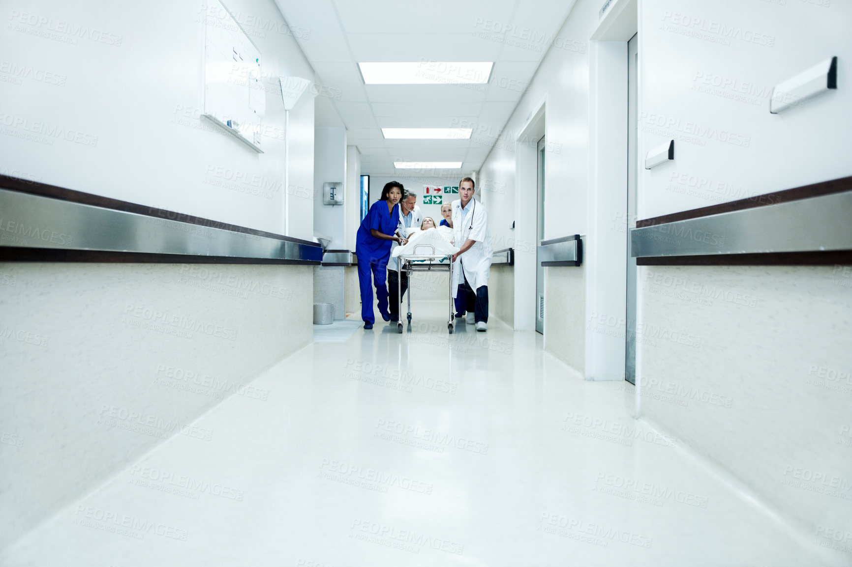Buy stock photo Surgery, accident and corridor with doctors in hospital for space, medical crisis and emergency. Healthcare, injury and operation with people and patient in clinic for urgency, help and hallway