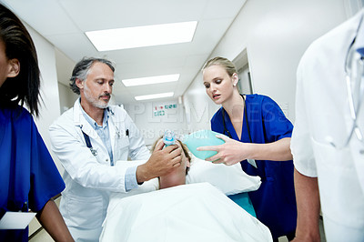 Buy stock photo Surgery, emergency and oxygen with doctors in hospital for running, medical crisis and accident. Healthcare, injury and operation with people and patient in clinic for teamwork, help and rush