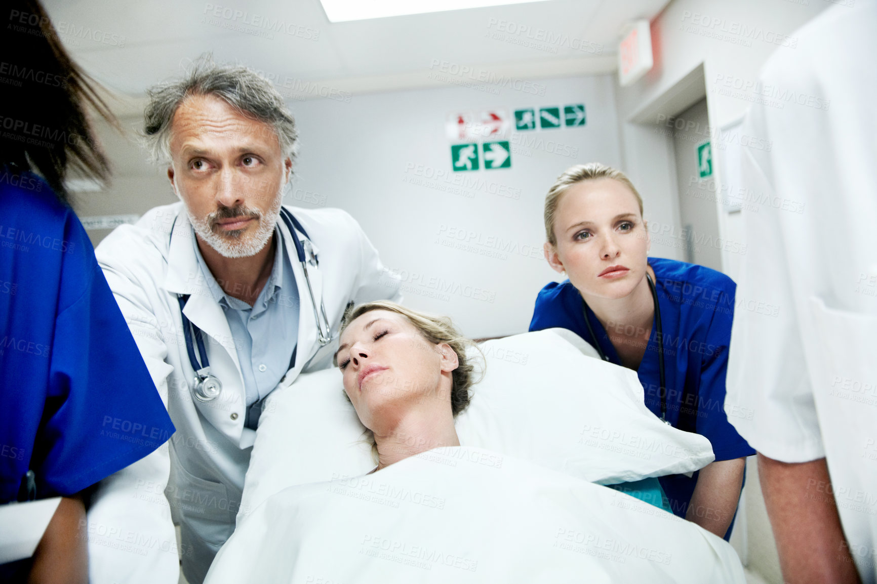 Buy stock photo Surgery, emergency and team with doctors in hospital for running, medical crisis and accident. Healthcare, injury and operation with people and patient in clinic for saving life, help and rush