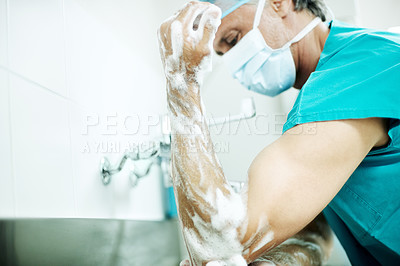 Buy stock photo Hygiene, soap or surgeon with cleaning in hospital for surgery preparation, medical safety or PPE. Mature man, doctor and washing hands for disinfection, sterile scrub or getting ready for operation
