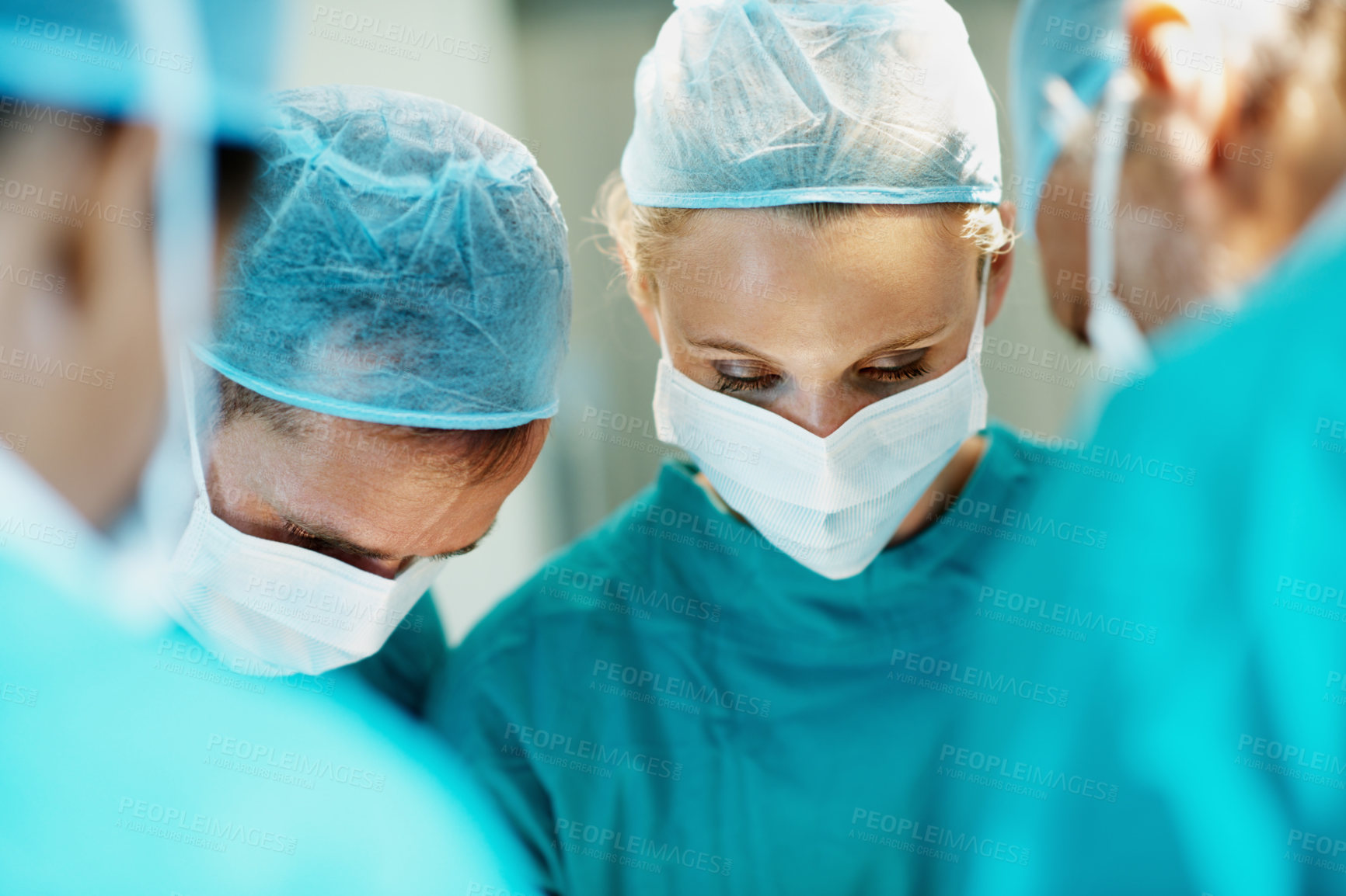Buy stock photo Surgery, medical and face mask with doctors in theater at hospital for operation, healing or accident. Procedure, healthcare and emergency rescue with team of people in operating room of clinic