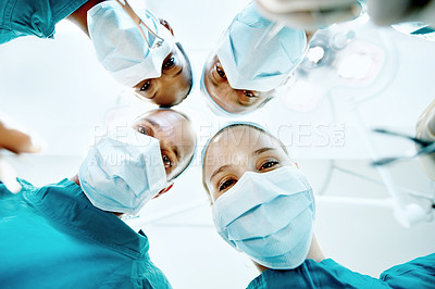 Buy stock photo Surgery, healthcare and portrait of doctors in theater at hospital for medical operation, healing or face mask. Procedure pov, team and emergency rescue with low angle of people in operating room