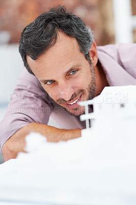 Buy stock photo Architecture, happy and man in office with model, building design and structure for planning. Creative, business and person with 3d layout for blueprint, prototype and inspection for engineer project