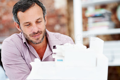 Buy stock photo Architecture, office or man with building model, design or structure for planning and construction. Creative, happy or mature person with 3d layout for blueprint, prototype or project for engineering