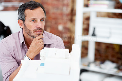 Buy stock photo Building, model and vision with business man in office for real estate, planning or prototype idea. Remodeling proposal, architect and 3d project with mature employee thinking in agency for process