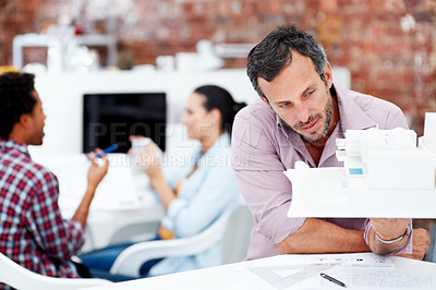 Buy stock photo Building, model and thinking with business man in office for real estate, planning or prototype idea. Remodeling proposal, architect vision and 3d project with mature employee in coworking agency