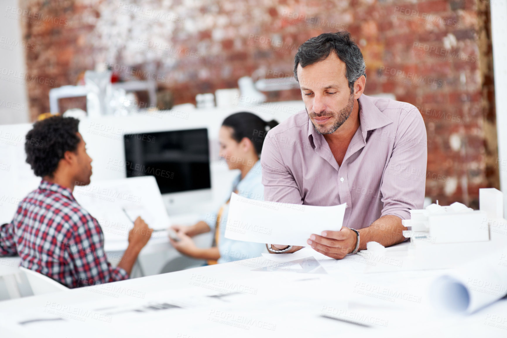 Buy stock photo Architect, man and reading blueprint in office to verify building design, spatial review or layout. Architecture staff, mature person and floor plan for structural integrity, code compliance or draft