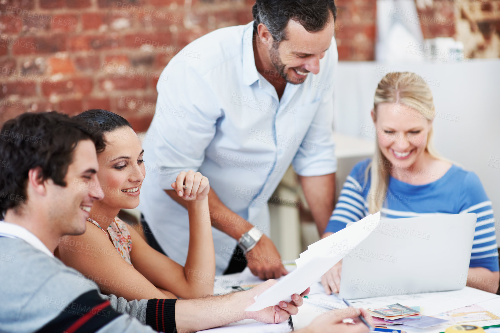 Buy stock photo Meeting, laptop and documents with business people in office for mentor, design team or brainstorming. Creative crit session, manager review and feedback with employees in startup agency for planning