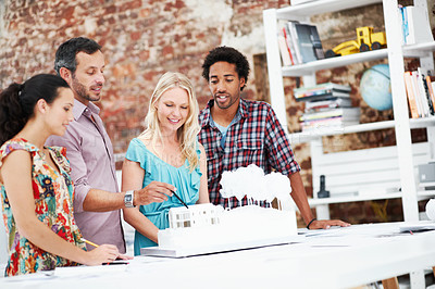 Buy stock photo Property development, meeting or team in agency with model, collaboration or feedback in design review. Building, people or architect with prototype, site plan or group evaluation of structure layout