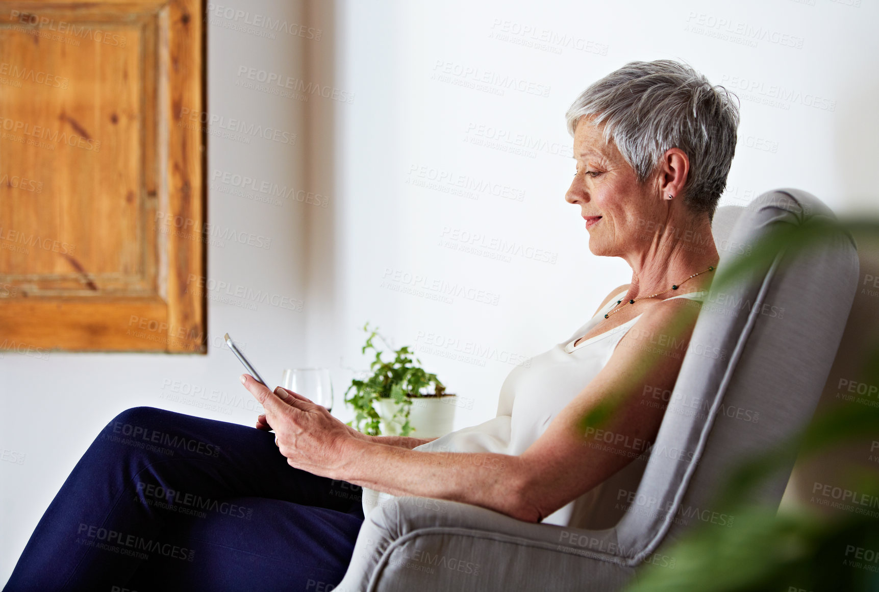 Buy stock photo Mature, woman and tablet with smile in home for streaming, reading online or internet with relaxing. Person, technology and search website with connectivity, network and app subscription at house