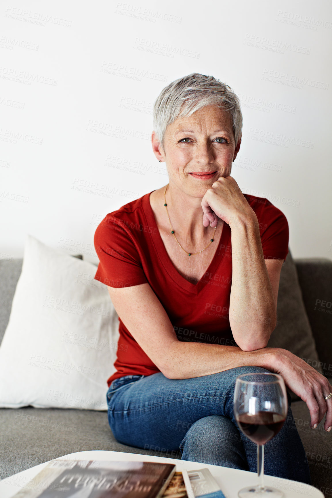 Buy stock photo Portrait of a mature woman sitting on her living room sofa drinking a glass of wine