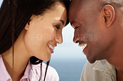 Buy stock photo Closeup shot of an affectionate couple standing face to face outside