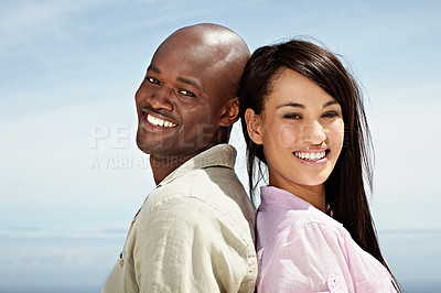 Buy stock photo Portrait of an affectionate couple standing back to back outside