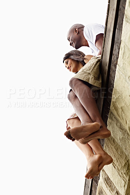 Buy stock photo Low angle shot of a young couple sitting on the edge of a boardwalk
