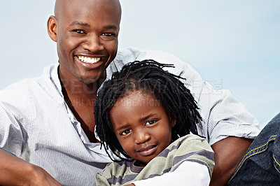 Buy stock photo Portrait of a smiling father and son sitting outside