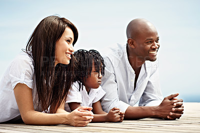 Buy stock photo Shot of a smiling young family standing outside
