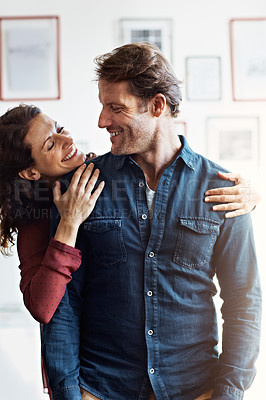 Buy stock photo Shot of an affectionate mature couple standing in their living room