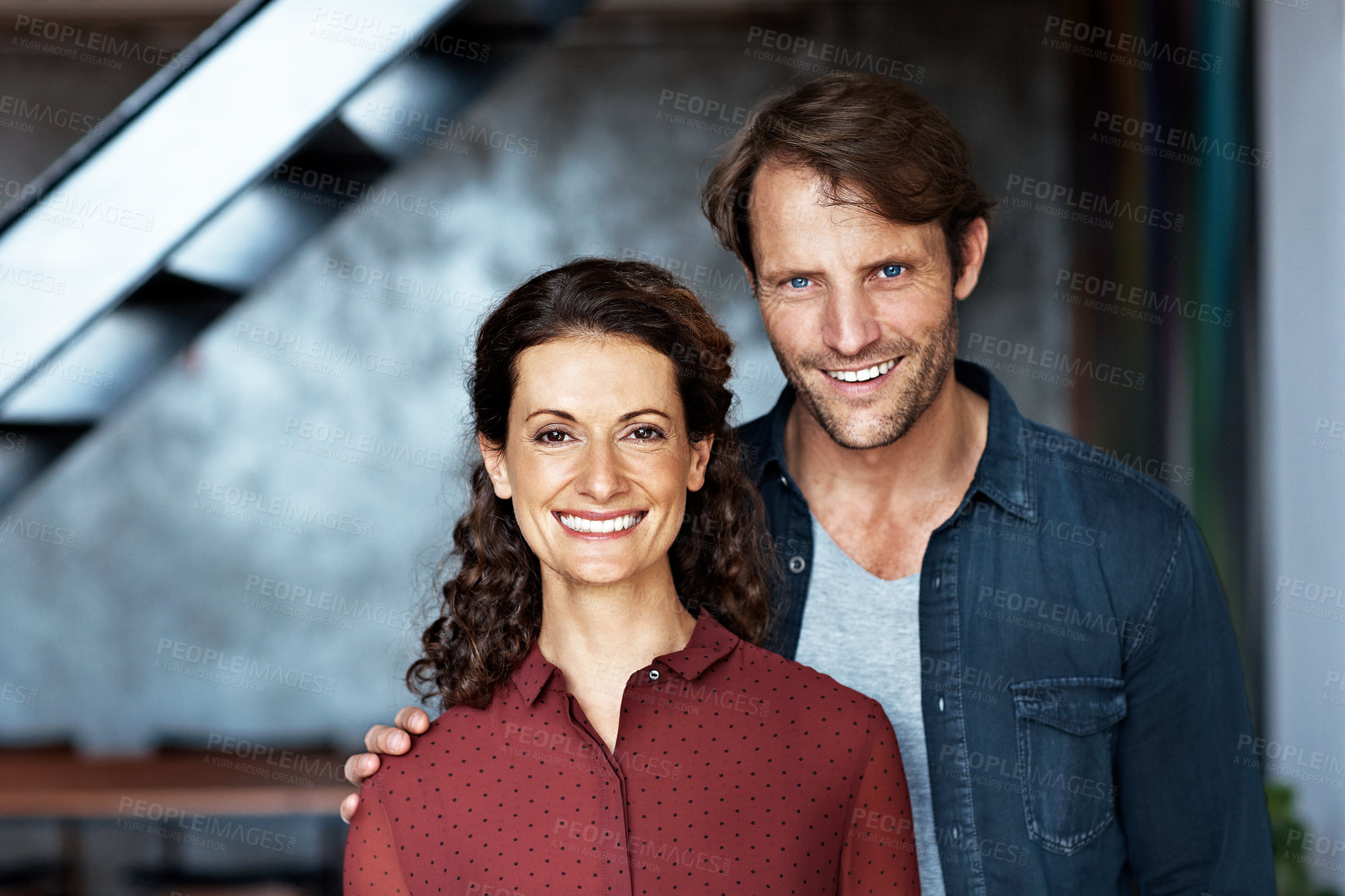 Buy stock photo Portrait of a smiling mature couple standing in their living room