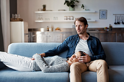 Buy stock photo Shot of a mature woman lying with her head on her husband's lap on the sofa